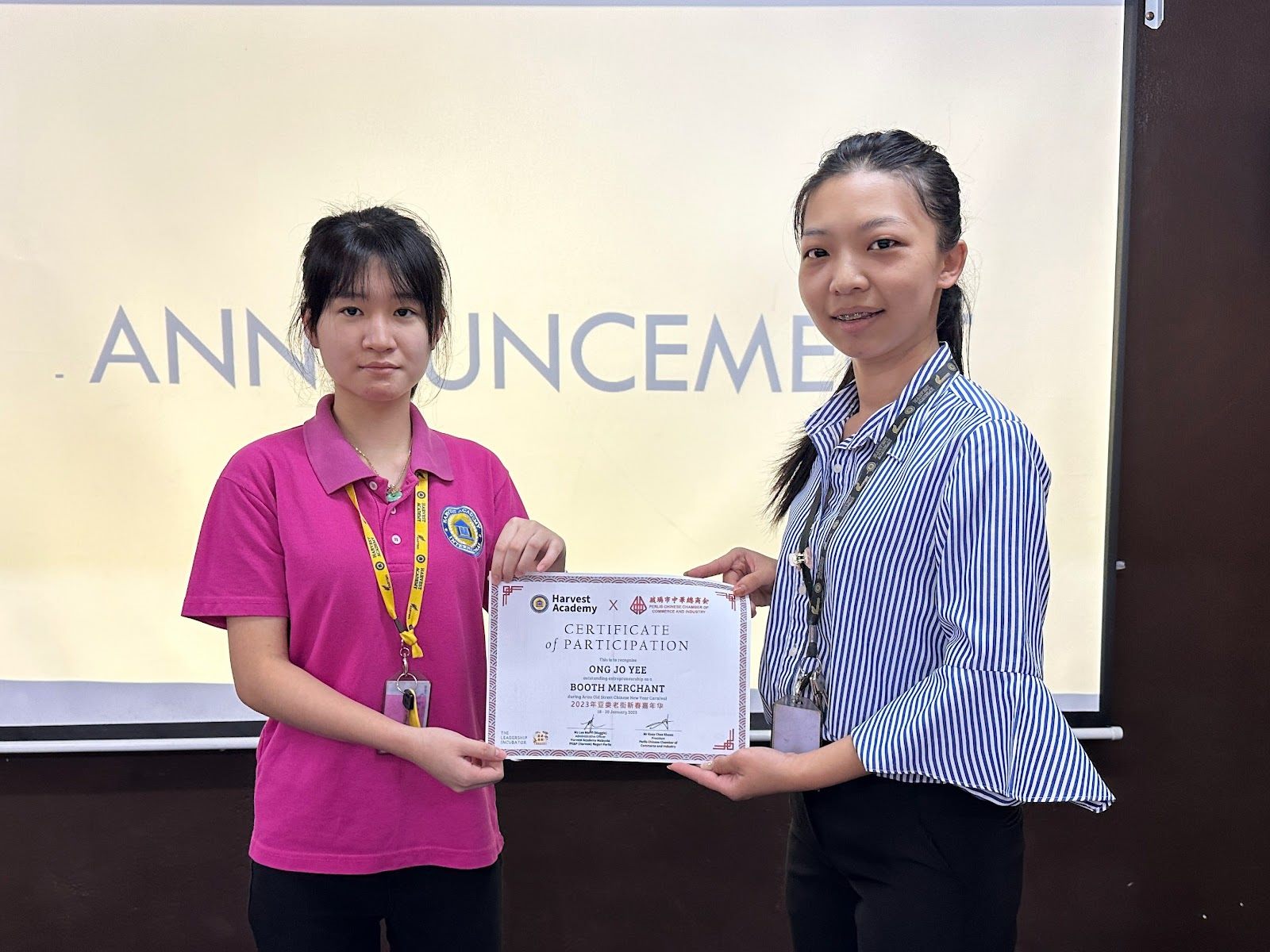 A Harvest Academy student receiving a certificate of participation