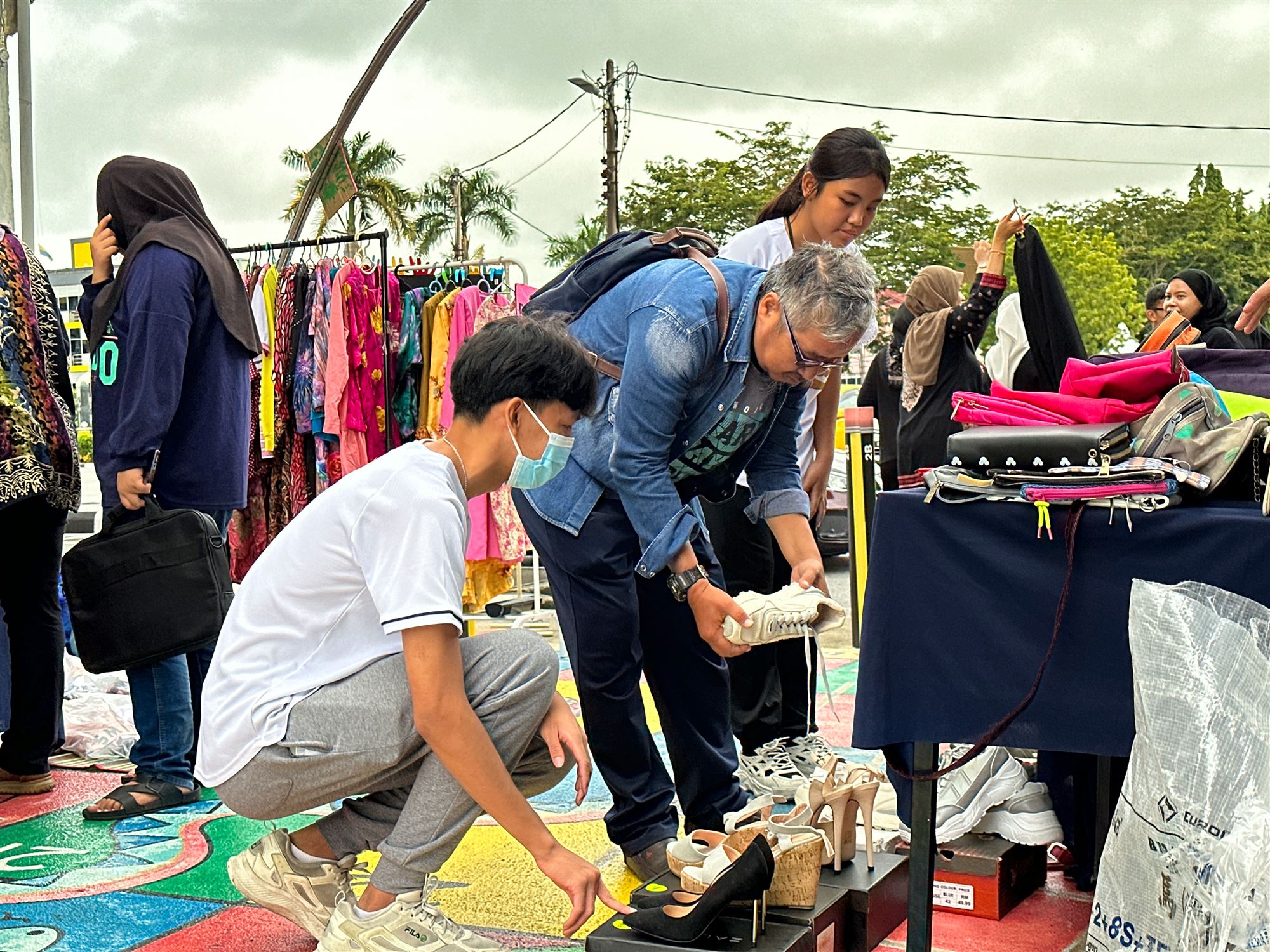 Students setting up a booth of donated goods at the charity garage sale