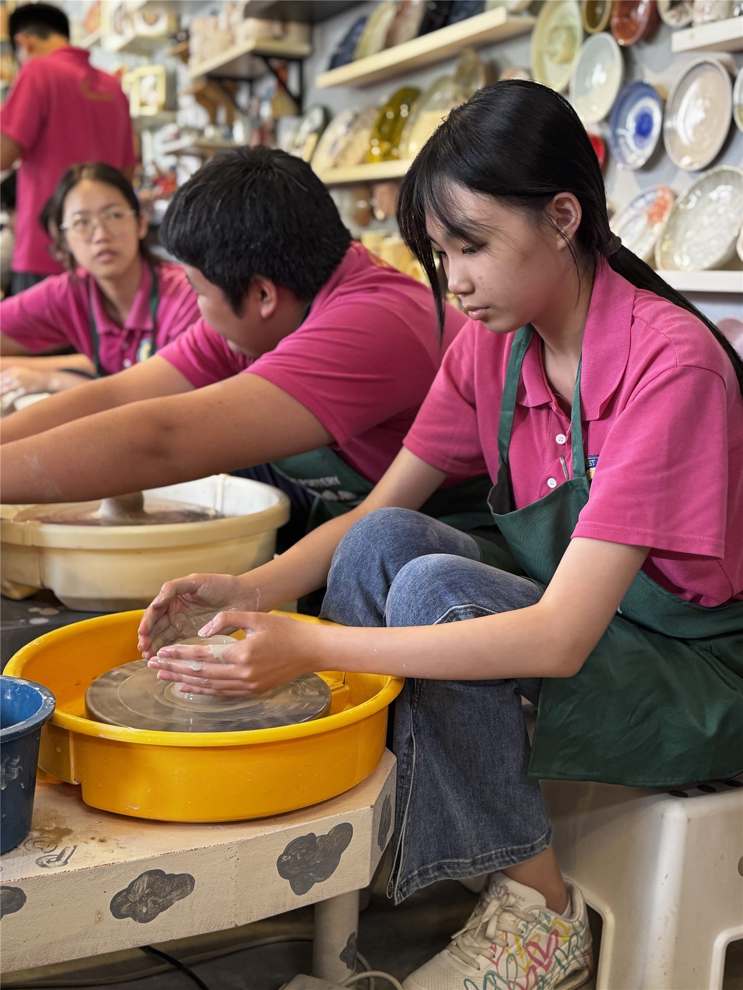 Harvest Academy student shaping clay on a potter's wheel at the H-Explore 2025 pottery workshop