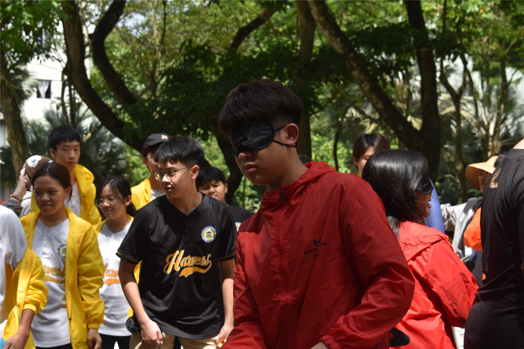 Classmates guiding a blindfolded Harvest Academy student during an H-Explore trust activity