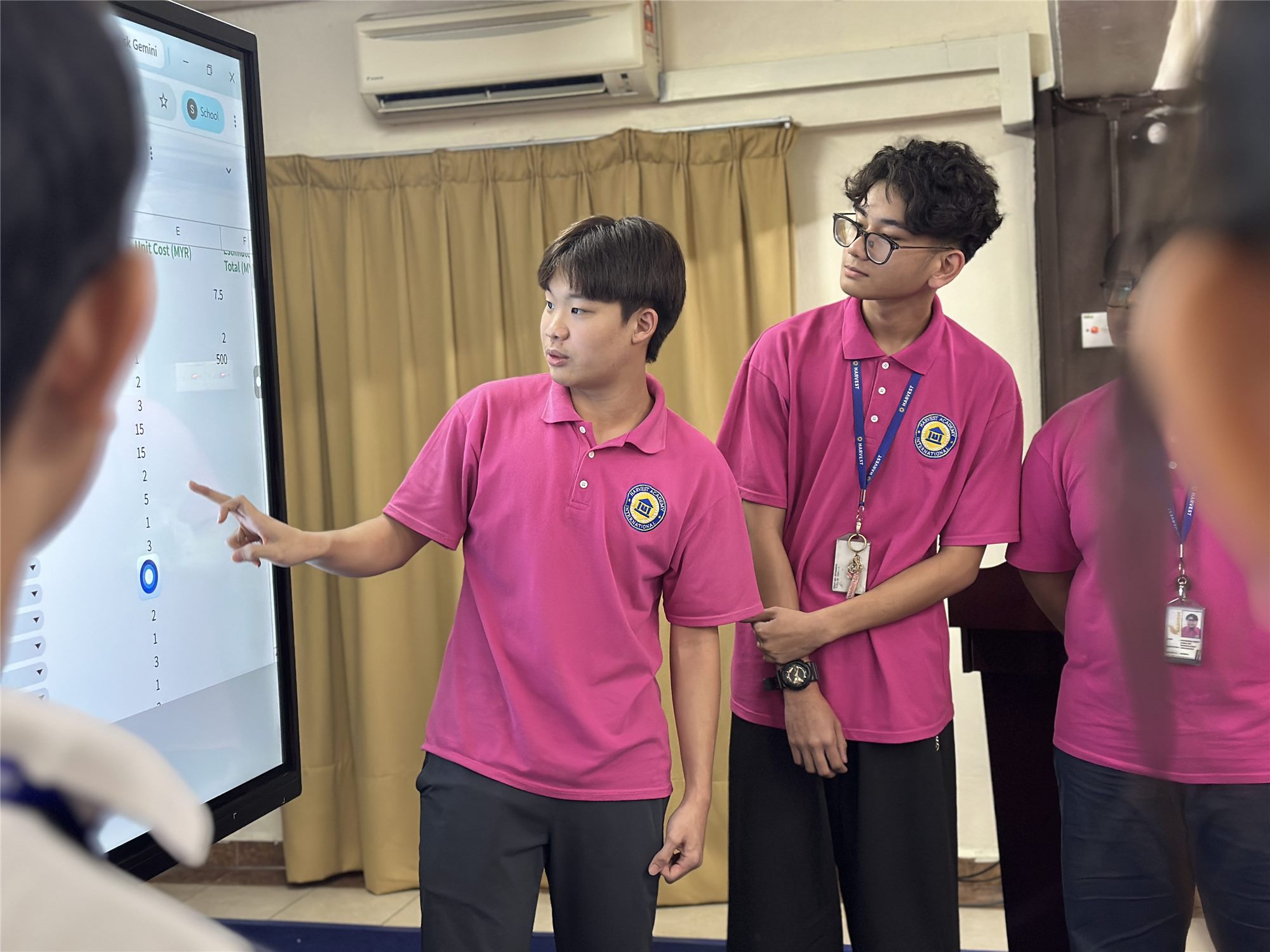 Harvest Academy students presenting their work to the class on the smartboard