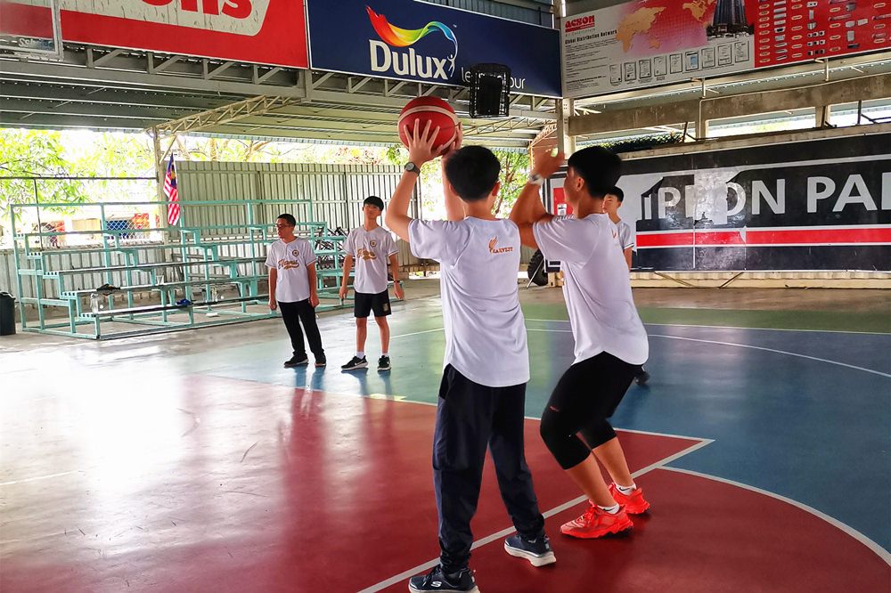 Harvest Academy students playing basketball at a nearby sports facility